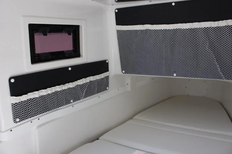 Slide: The Image of 2025 Tidewater 320 CC Adventure cabin interior with storage nets and cushioned seating. - 34