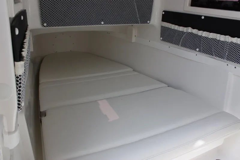 Slide: The Image of 2025 Tidewater 320 CC Adventure cabin interior with white cushioned seating. - 35