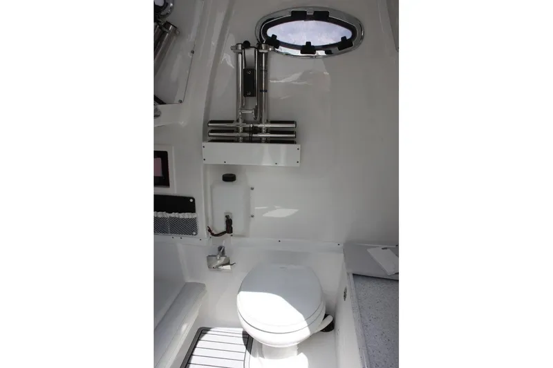 Slide: The Image of Interior of 2025 Tidewater 320 CC Adventure boat featuring a compact marine toilet. - 36