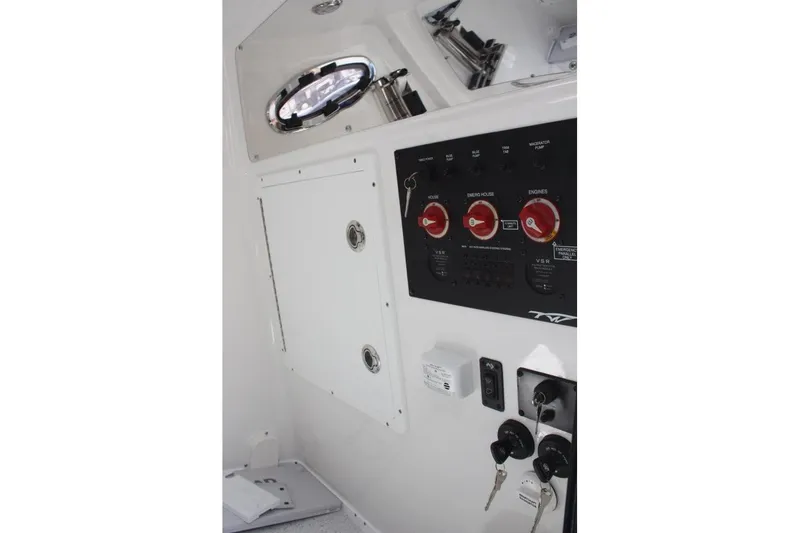 Slide: The Image of Control panel of 2025 Tidewater 320 CC Adventure boat with switches and keys. - 37