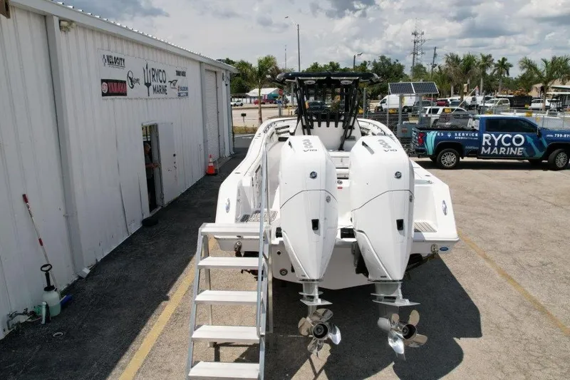 Slide: The Image of 2025 Tidewater 320 CC Adventure boat with dual engines at Ryco Marine service center. - 4