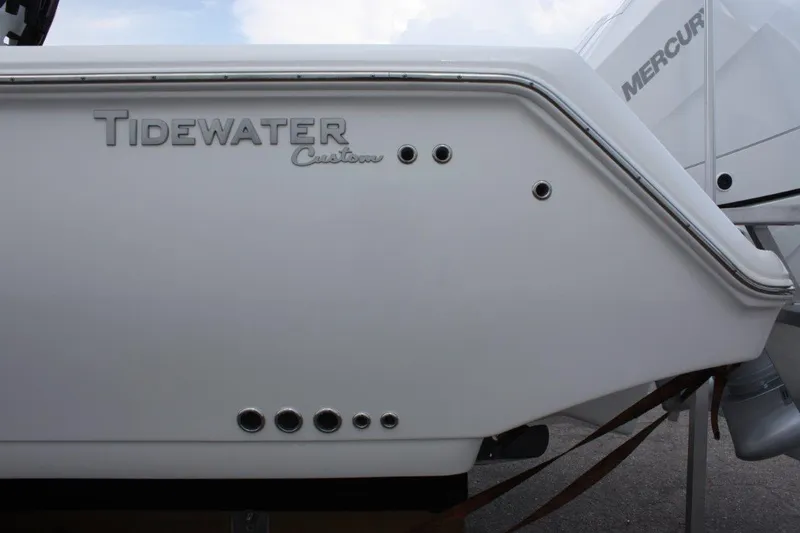 Slide: The Image of 2025 Tidewater 320 CC Adventure boat with Mercury engine, side view. - 44