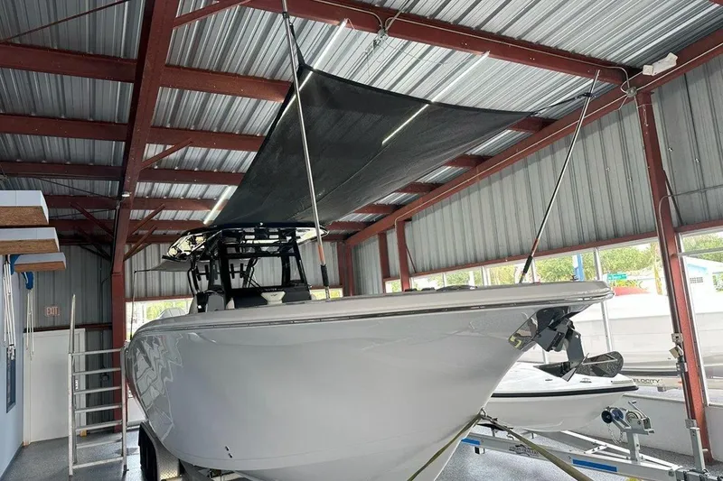 Slide: The Image of 2025 Tidewater 320 CC Adventure boat in a metal storage facility. - 45