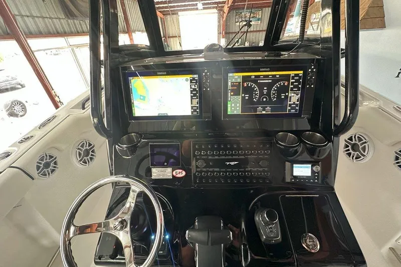Slide: The Image of 2025 Tidewater 320 CC Adventure boat dashboard with advanced navigation and control systems. - 47