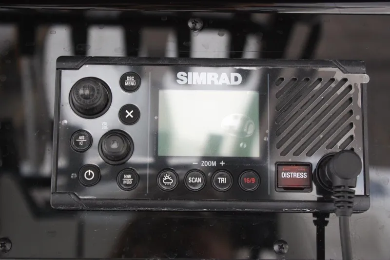 Slide: The Image of Simrad marine radio on 2025 Tidewater 320 CC Adventure boat dashboard. - 48