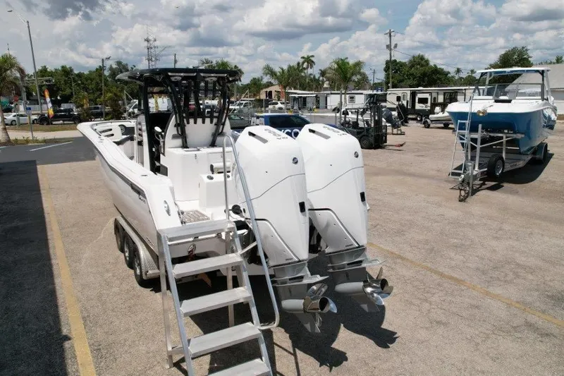 Slide: The Image of 2025 Tidewater 320 CC Adventure boat with dual engines on a trailer. - 5