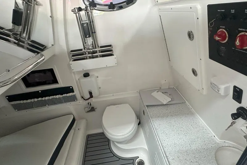 Slide: The Image of 2025 Tidewater 320 CC Adventure boat interior with toilet and control panel. - 51