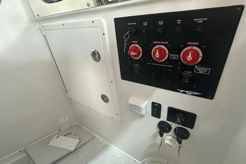 Slide: The Image of Control panel of 2025 Tidewater 320 CC Adventure boat with switches and keys. - 52