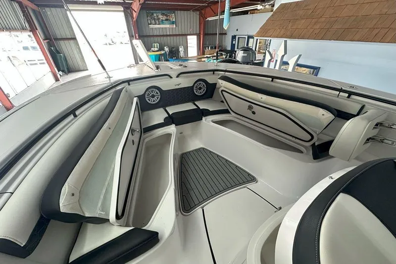 Slide: The Image of 2025 Tidewater 320 CC Adventure boat interior with seating and storage compartments. - 54