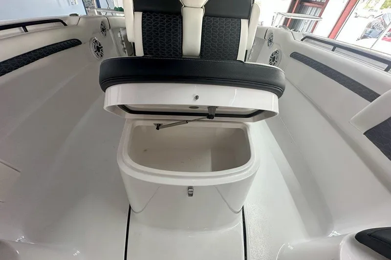Slide: The Image of 2025 Tidewater 320 CC Adventure boat seat with open storage compartment. - 56