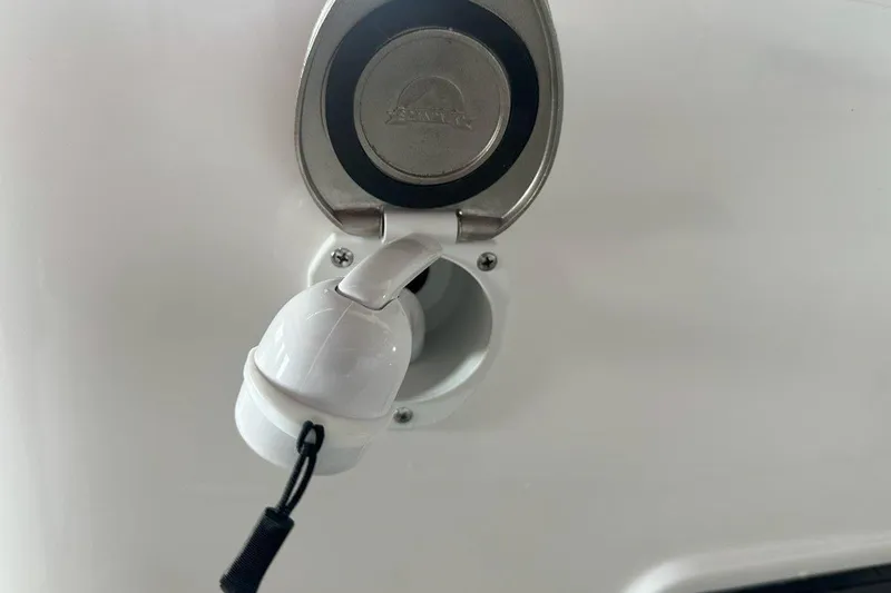 Slide: The Image of Fuel cap of 2025 Tidewater 320 CC Adventure boat, featuring a secure latch design. - 62