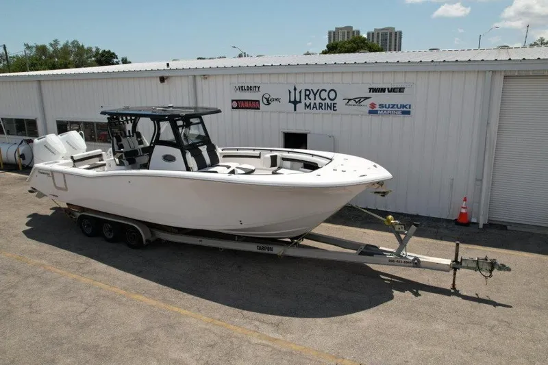 Slide: The Image of 2025 Tidewater 320 CC Adventure boat on trailer at Ryco Marine dealership. - 7