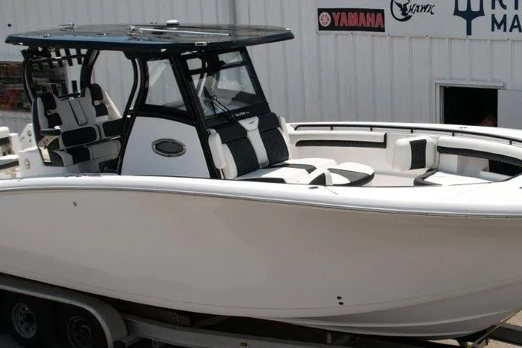 Slide: The Image of 2025 Tidewater 320 CC Adventure boat on trailer, featuring sleek design and modern amenities. - 8