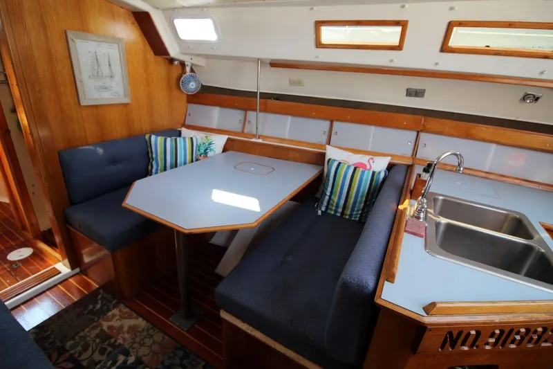 Slide: The Image of Interior of 1987 Hunter 34 sailboat with dining area and kitchenette. - 14
