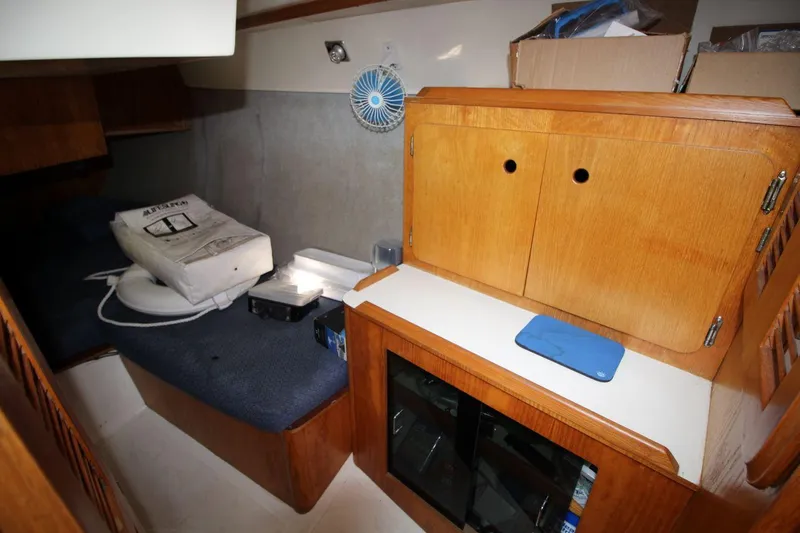 Slide: The Image of Interior of 1987 Hunter 34 sailboat with wooden cabinetry and storage area. - 20