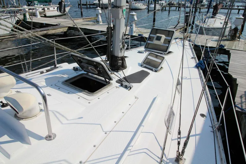 Slide: The Image of 1987 Hunter 34 sailboat deck with open hatches at marina. - 7