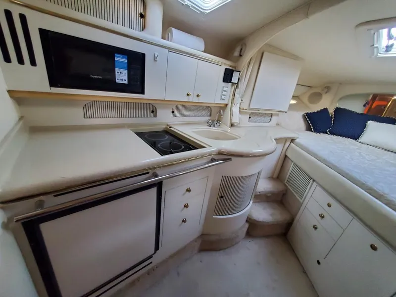 Slide: The Image of Interior of 2000 Sea Ray 310 Sundancer yacht with kitchenette and bed. - 14