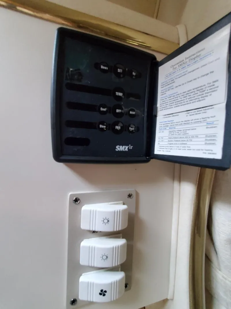 Slide: The Image of Control panel inside a 2000 Sea Ray 310 Sundancer boat cabin. - 17