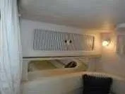 Slide: The Image of Interior cabin of 2000 Sea Ray 310 Sundancer with cozy seating and ambient lighting. - 18