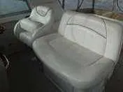 Slide: The Image of 2000 Sea Ray 310 Sundancer interior seating, featuring white leather upholstery. - 22