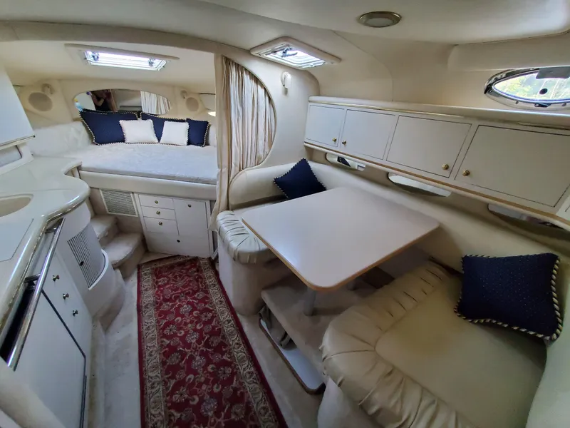 Slide: The Image of Interior of 2000 Sea Ray 310 Sundancer yacht with cozy seating and sleeping area. - 3