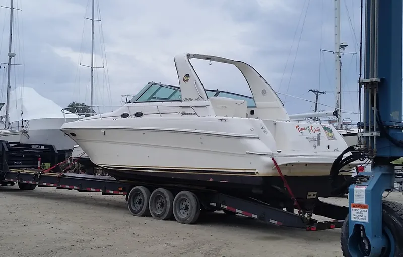 Slide: The Image of 2000 Sea Ray 310 Sundancer boat on trailer at marina. - 4