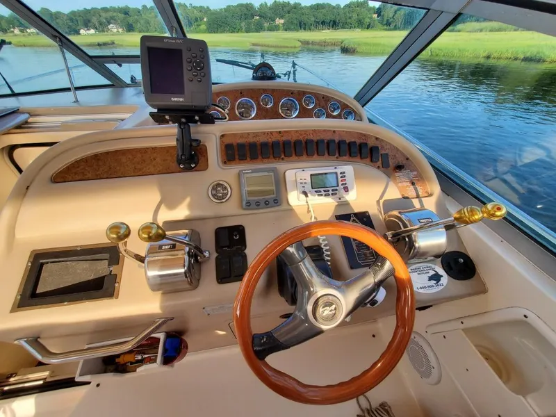 Slide: The Image of Cockpit of 2000 Sea Ray 310 Sundancer with steering wheel and navigation equipment. - 7