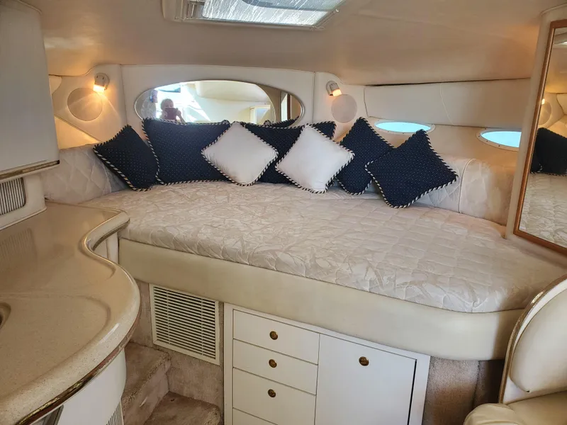 Slide: The Image of Interior of 2000 Sea Ray 310 Sundancer with cozy bed and decorative pillows. - 8