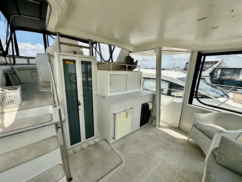 Slide: The Image of Interior of 1995 Carver 440 Aft Cabin Motor Yacht with seating and windows. - 12