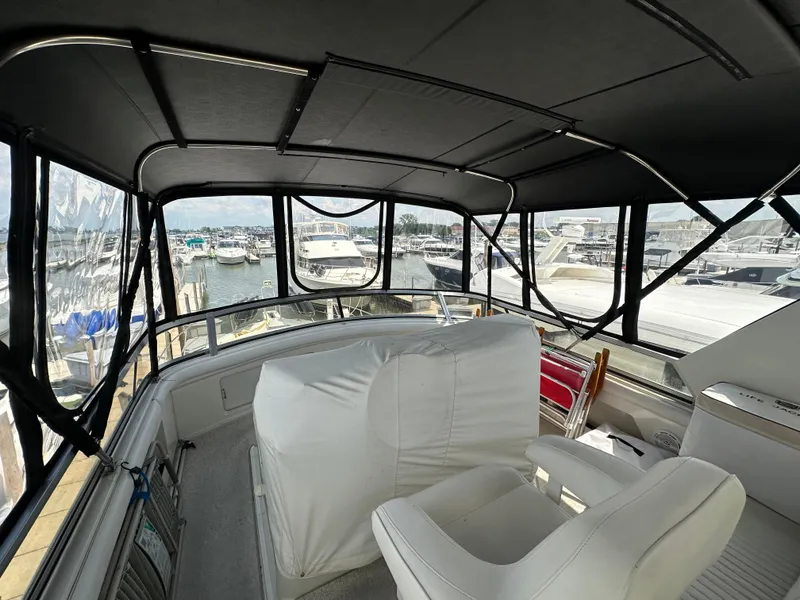 Slide: The Image of 1995 Carver 440 Aft Cabin Motor Yacht interior with marina view. - 14