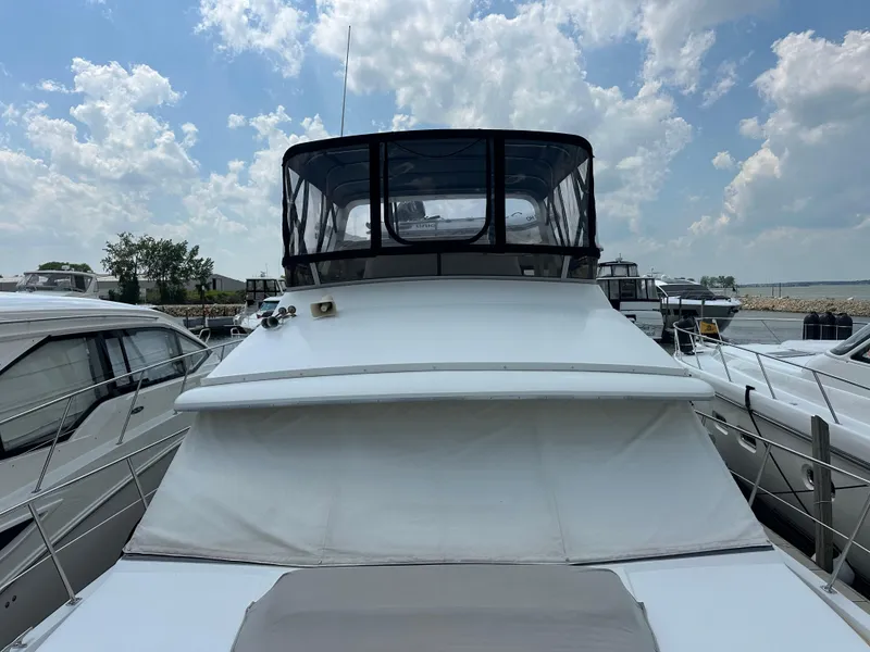 Slide: The Image of Luxurious bedroom in 1995 Carver 440 Aft Cabin Motor Yacht with elegant decor. - 4