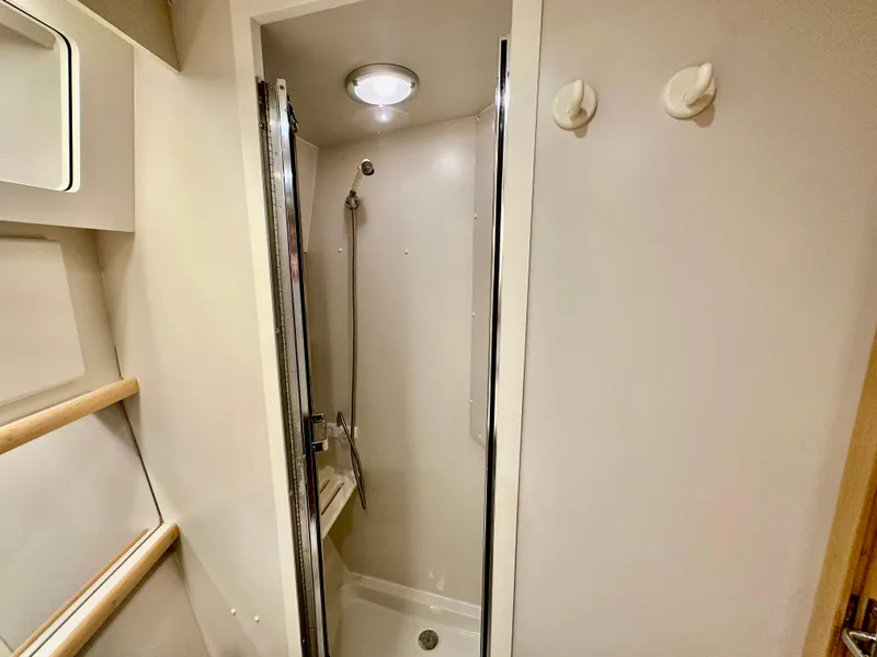 Slide: The Image of 1995 Carver 440 Aft Cabin Motor Yacht docked under a partly cloudy sky. - 41