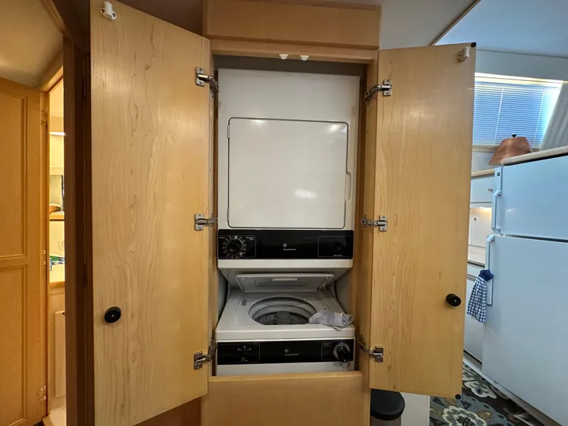 Slide: The Image of 1995 Carver 440 Aft Cabin Motor Yacht docked at marina under blue sky. - 42