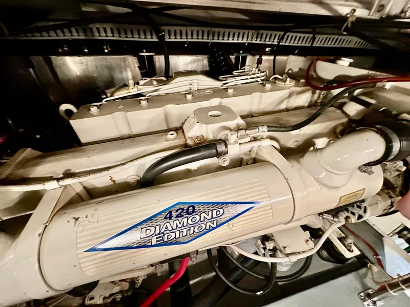 Slide: The Image of 1995 Carver 440 Aft Cabin Motor Yacht interior with cozy dining area and wooden flooring. - 22