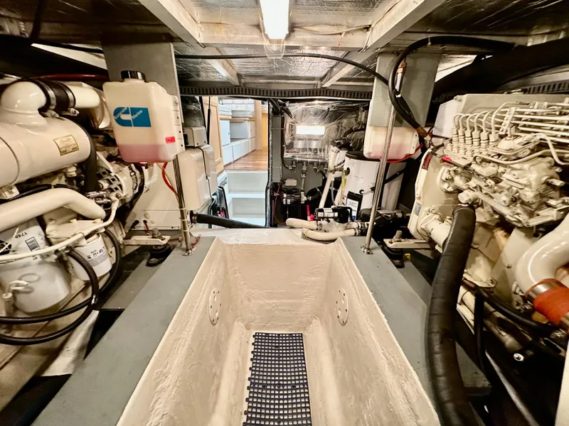 Slide: The Image of 1995 Carver 440 Aft Cabin Motor Yacht kitchen with white cabinets and appliances. - 24