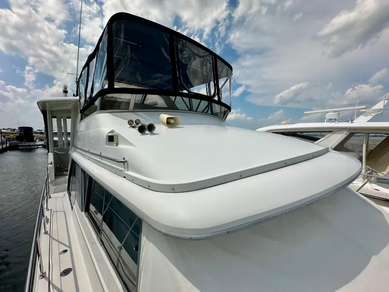 Slide: The Image of 1995 Carver 440 Aft Cabin Motor Yacht kitchen with white cabinets and appliances. - 3