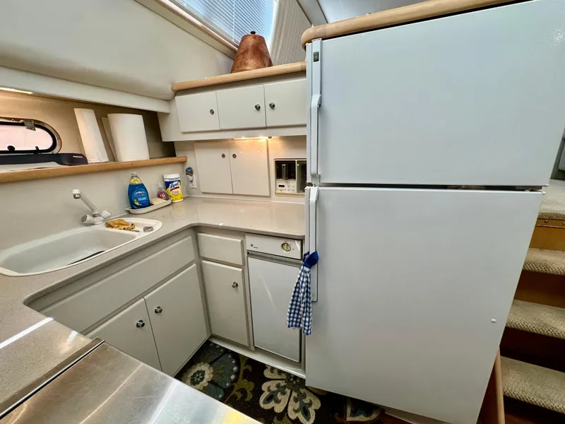 Slide: The Image of Bathroom interior of 1995 Carver 440 Aft Cabin Motor Yacht, featuring sink and toilet. - 36