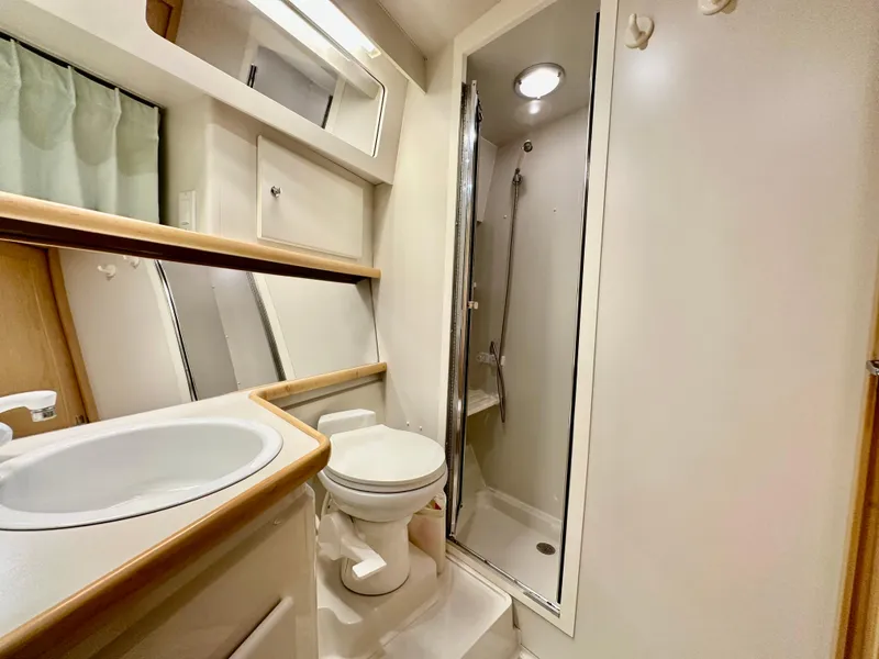 Slide: The Image of 1995 Carver 440 Aft Cabin Motor Yacht docked under a partly cloudy sky. - 40