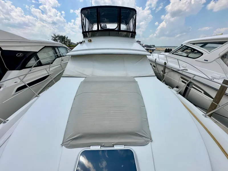 Slide: The Image of 1995 Carver 440 Aft Cabin Motor Yacht helm with steering wheel and navigation controls. - 5