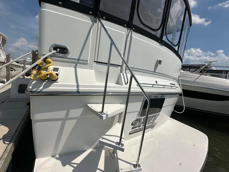 Slide: The Image of Close-up of 1995 Carver 440 Aft Cabin Motor Yacht logo on hull. - 7