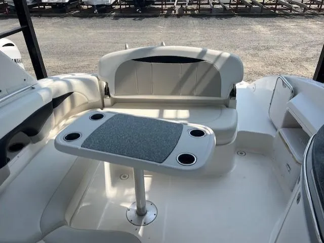 Slide: The Image of 2008 Chaparral SSX 276 boat interior with seating and table, featuring cup holders. - 11
