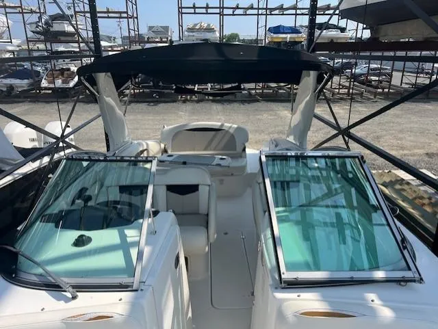 Slide: The Image of 2008 Chaparral SSX 276 boat with open cockpit and dual windshields in a marina. - 17