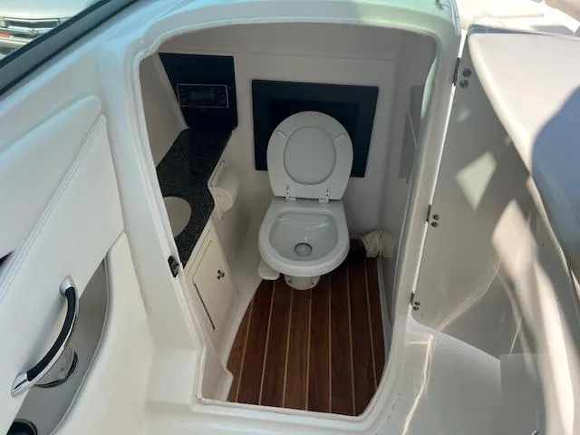 Slide: The Image of 2008 Chaparral SSX 276 boat interior with toilet and wooden flooring. - 18