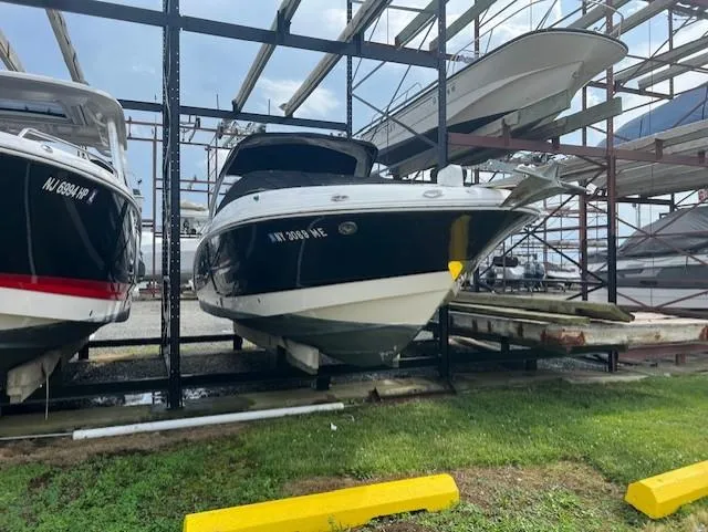 Slide: The Image of 2008 Chaparral SSX 276 boat stored on a rack in a marina. - 2