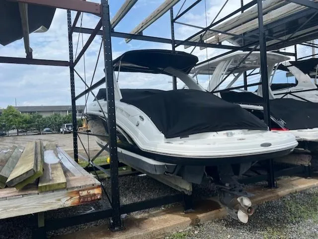 Slide: The Image of 2008 Chaparral SSX 276 boat stored on a rack, covered and secured outdoors. - 5
