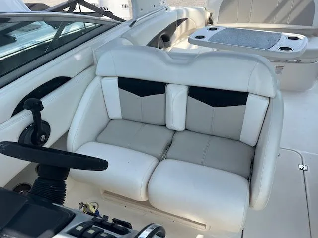 Slide: The Image of 2008 Chaparral SSX 276 boat interior with white seating and steering wheel. - 7