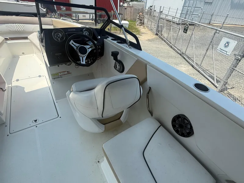 Slide: The Image of 2022 Glastron GTD 220 boat interior with steering wheel and seating area. - 10