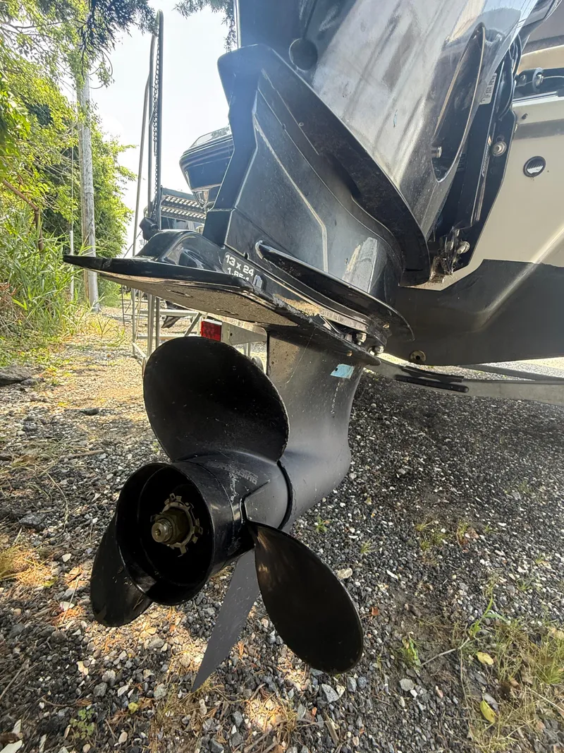 Slide: The Image of Close-up of a 2022 Glastron GTD 220 boat propeller on gravel surface. - 15