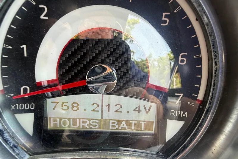 Slide: The Image of Close-up of 2022 Glastron GTD 220 tachometer displaying 758 hours and 12.4 volts. - 18