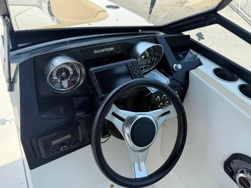 Slide: The Image of 2022 Glastron GTD 220 dashboard with steering wheel and gauges. - 6